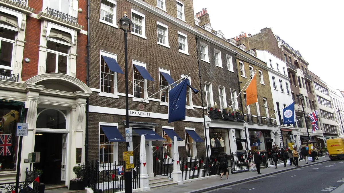 Savile Row in Mayfair, London, with tailors' flags hanging over the street