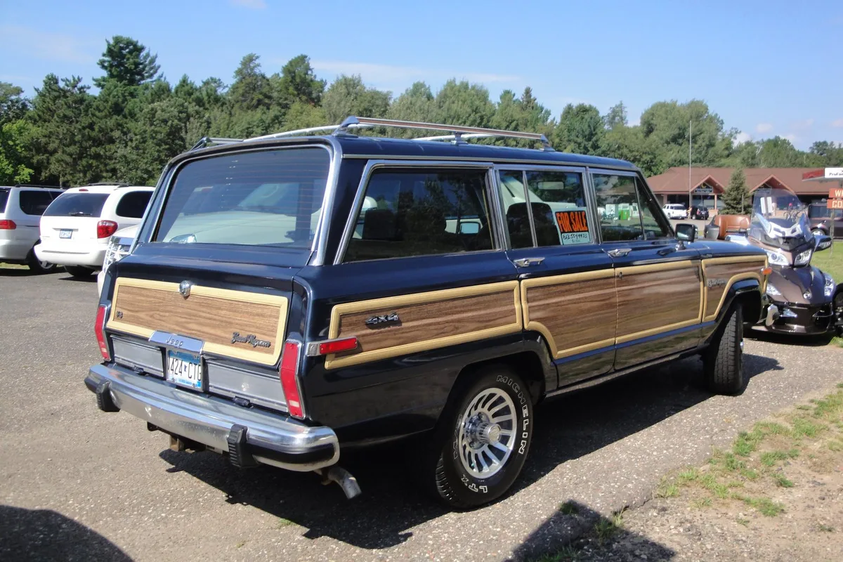 A wood-panelled Jeep Grand Wagoneer: a handsome car, until the rear window begins to collect prep school stickers.