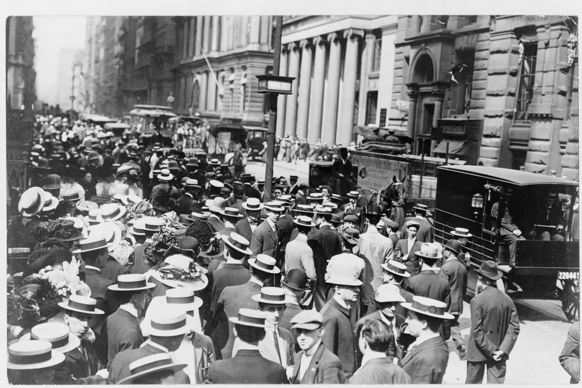 A crowd on Wall Street in front of Trinity Church in the 1910s. Every generation on the Street believes it is living through something…