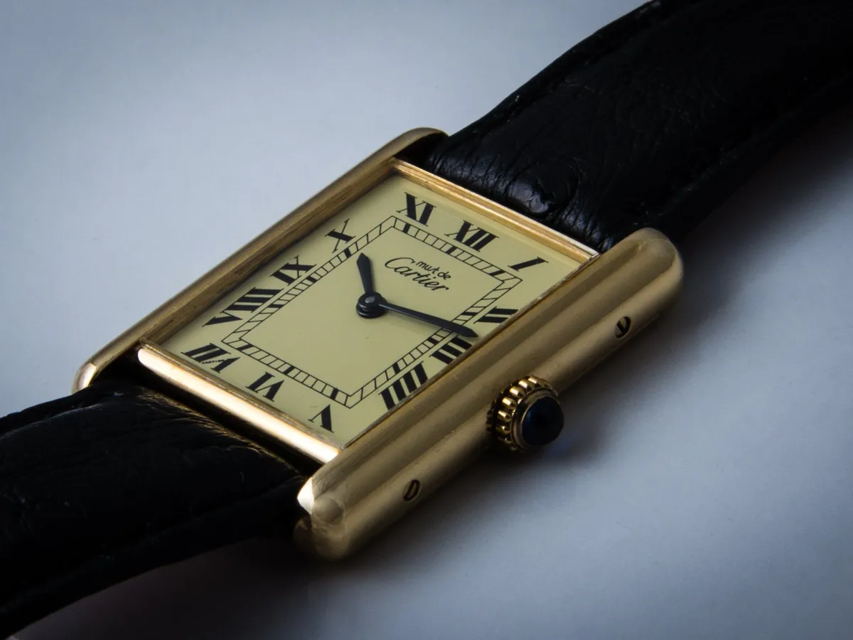 A gold Cartier Tank with a Roman numeral dial