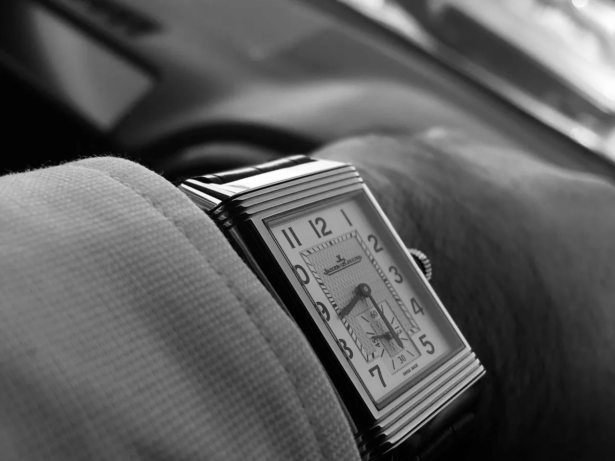 A Jaeger-LeCoultre Reverso on a wrist, in black and white